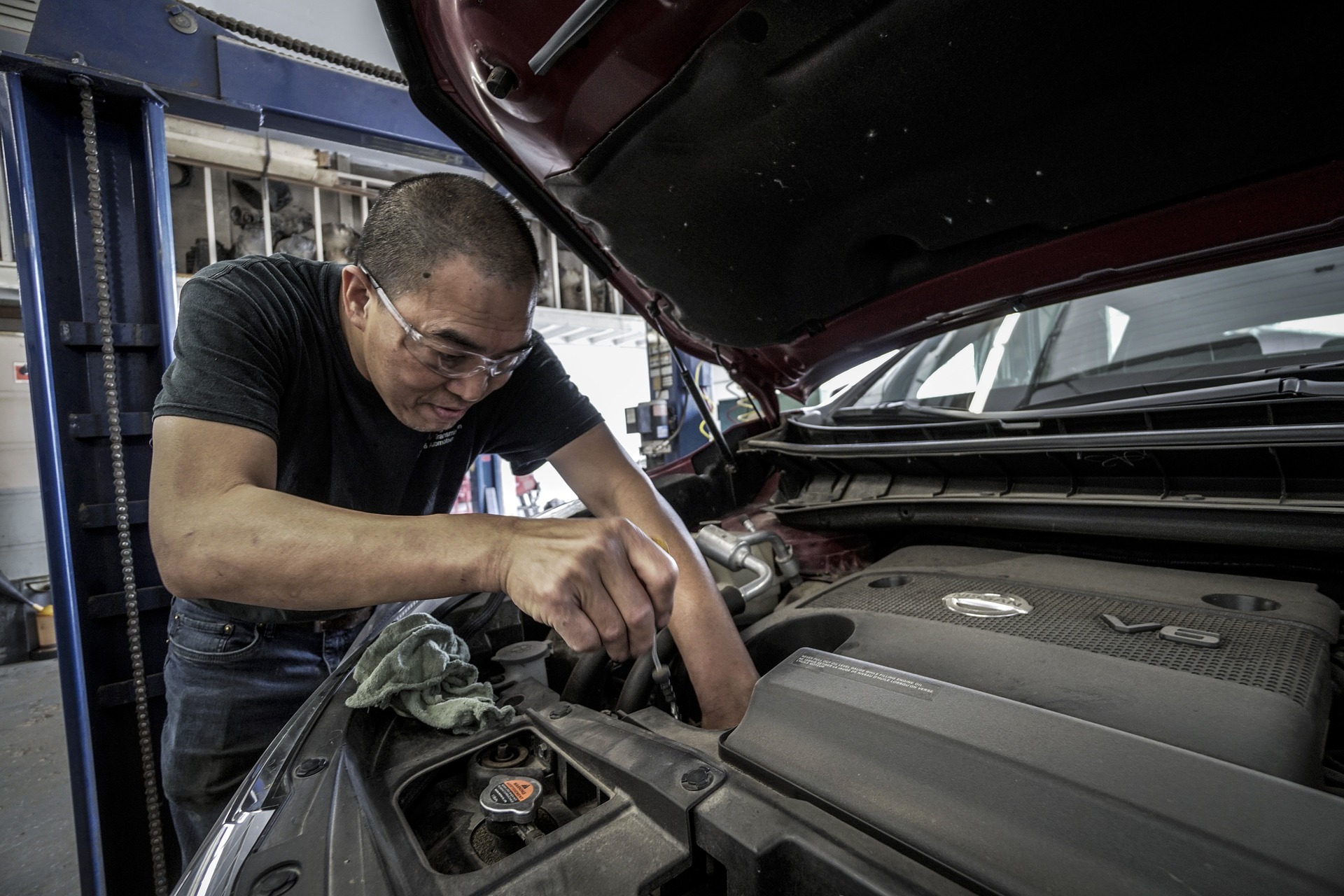 A mechanic working on a car engine